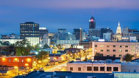 The downtown skyline of Lansing with the Michigan State Capitol in the background, Michigan at night.